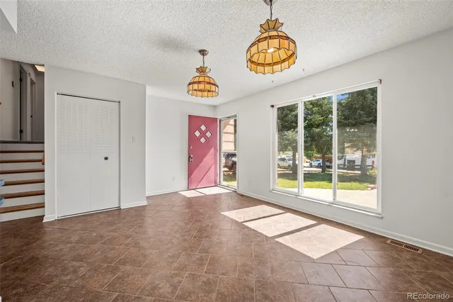 an empty room with windows and entrance