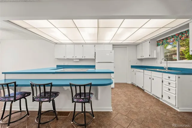 a kitchen with stainless steel appliances cabinets and a table