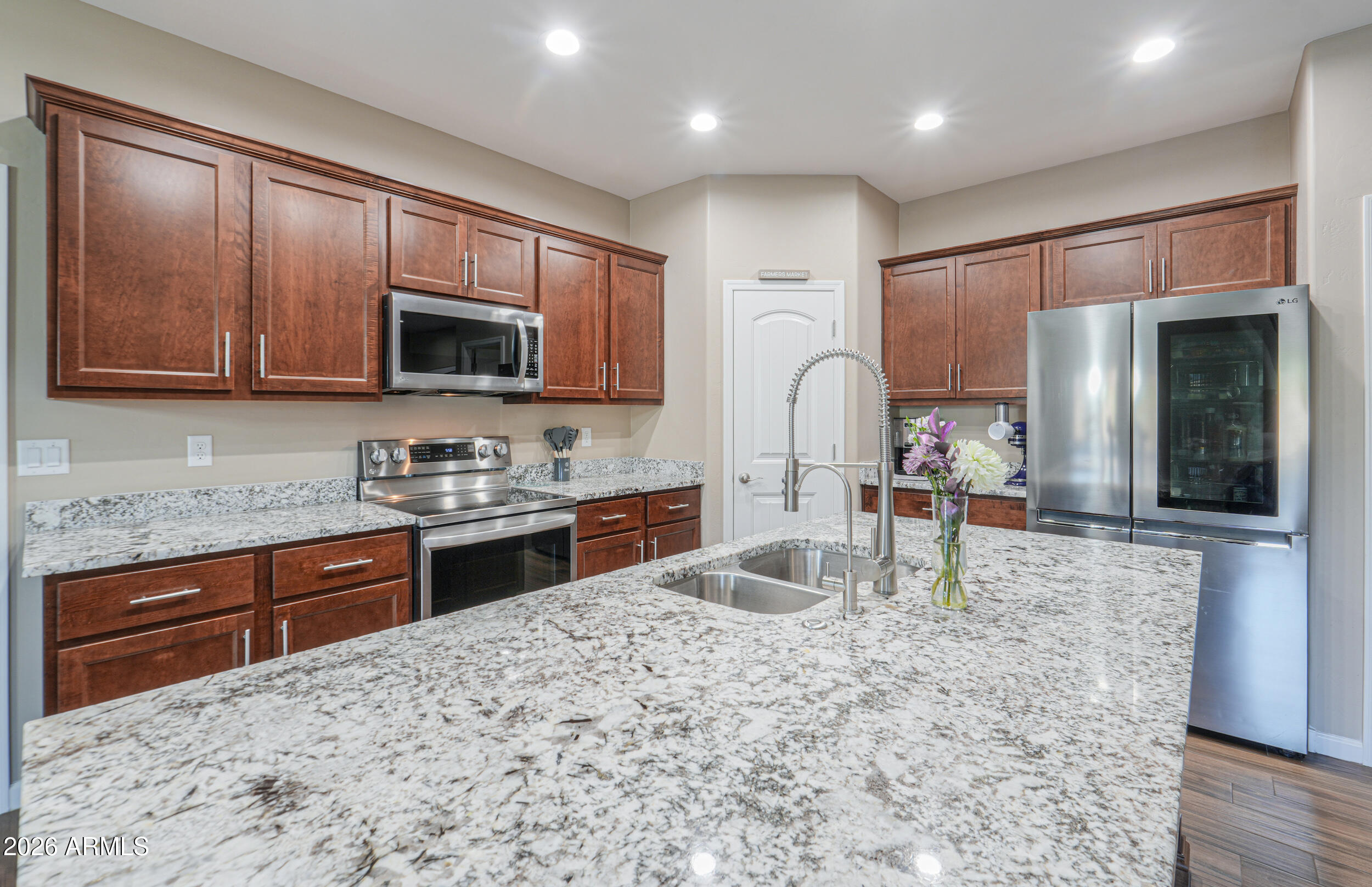 1487 South Mountain View Road Apache Junction, AZ 85119 - Photo 13 of 60 a kitchen with stainless steel appliances granite countertop a stove sink and cabinets