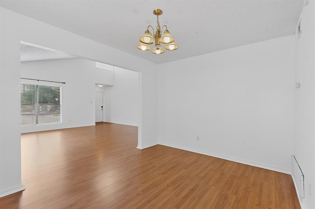 635 Haines Avenue Dallas, TX 75208 - Photo 12 of 36 wooden floor in an empty room with a window