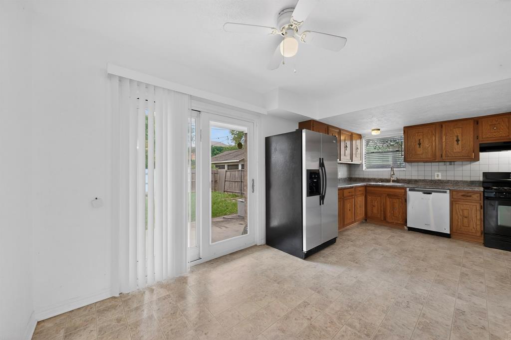 635 Haines Avenue Dallas, TX 75208 - Photo 15 of 36 a kitchen with stainless steel appliances a refrigerator and a sink