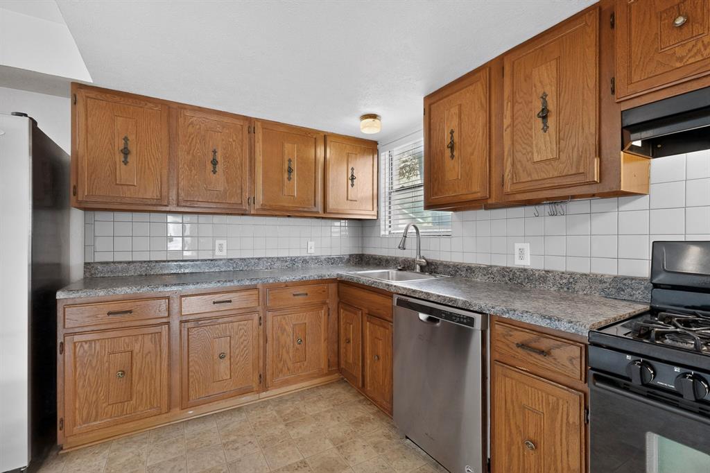 635 Haines Avenue Dallas, TX 75208 - Photo 18 of 36 a kitchen with stainless steel appliances granite countertop a sink stove and cabinets