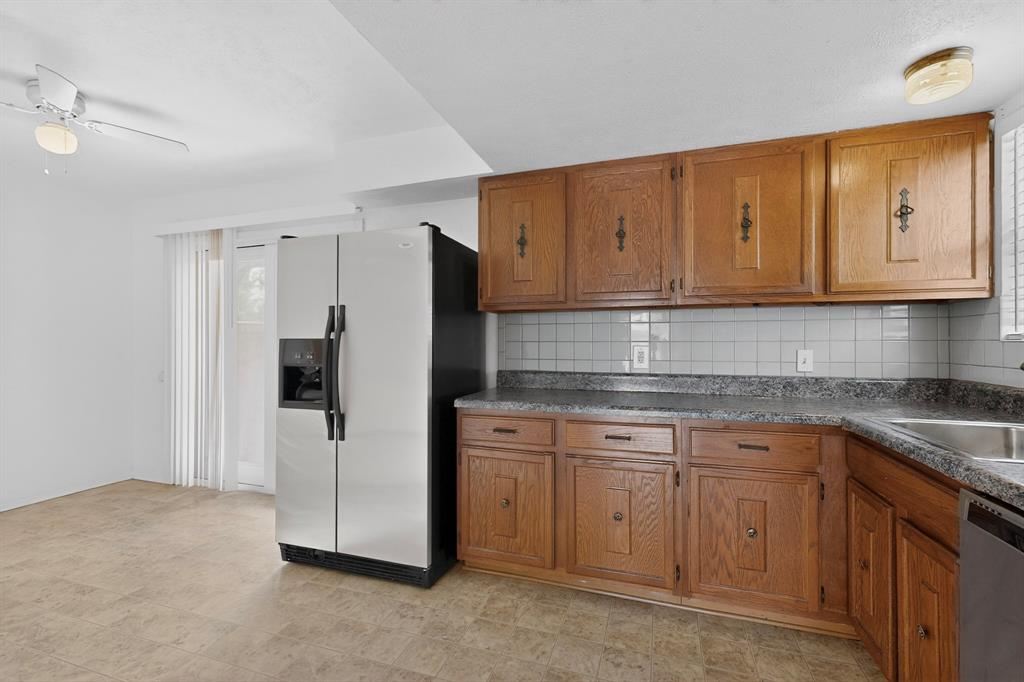 635 Haines Avenue Dallas, TX 75208 - Photo 19 of 36 a kitchen with cabinets and stainless steel appliances