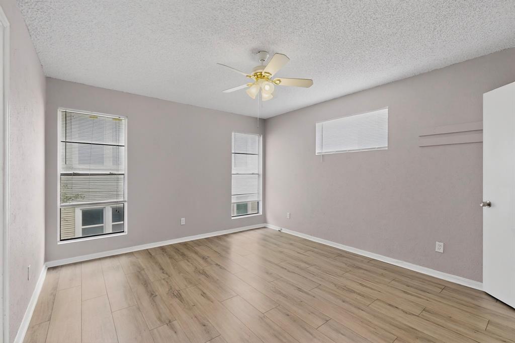 635 Haines Avenue Dallas, TX 75208 - Photo 22 of 36 a view of an empty room with a window and wooden floor