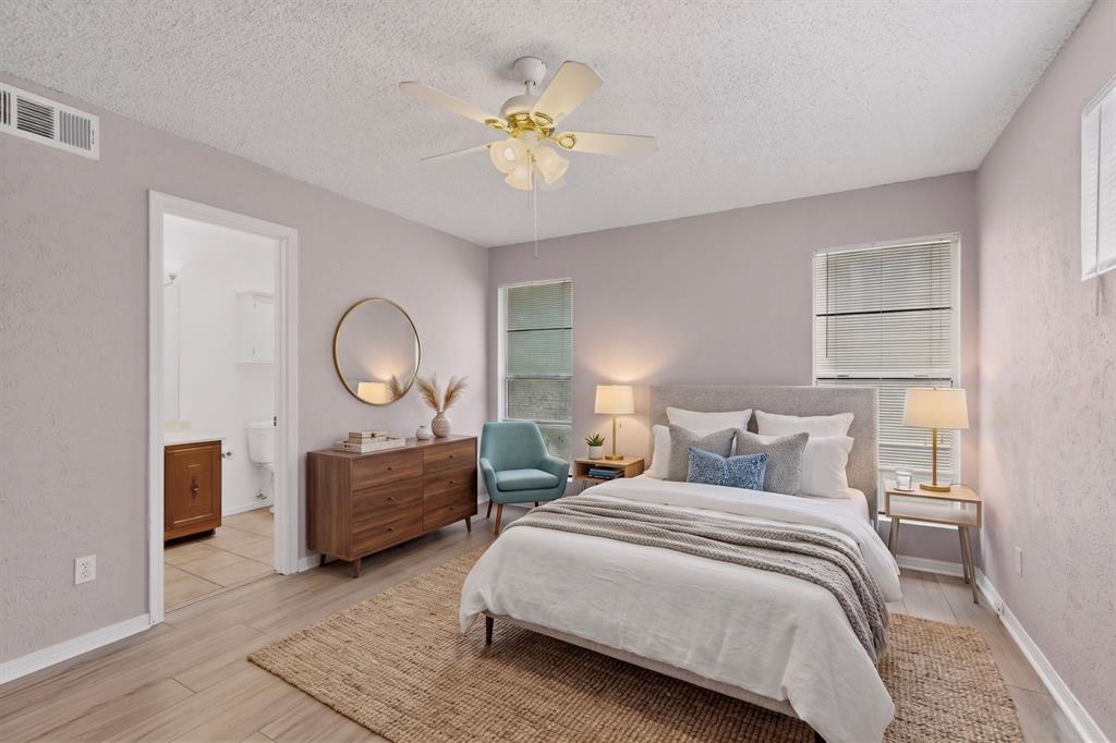 635 Haines Avenue Dallas, TX 75208 - Photo 24 of 36 a bedroom with bed and a chandelier