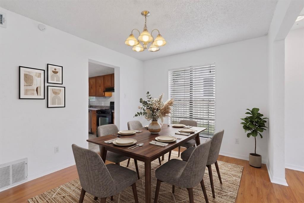 635 Haines Avenue Dallas, TX 75208 - Photo 3 of 36 a view of a dining room with furniture and wooden floor