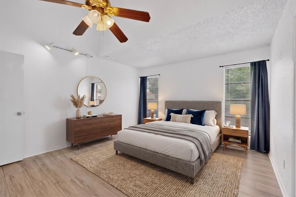635 Haines Avenue Dallas, TX 75208 - Photo 4 of 36 a bedroom with a bed and wooden floor