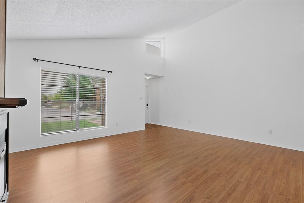 635 Haines Avenue Dallas, TX 75208 - Photo 9 of 36 an empty room with wooden floor and windows