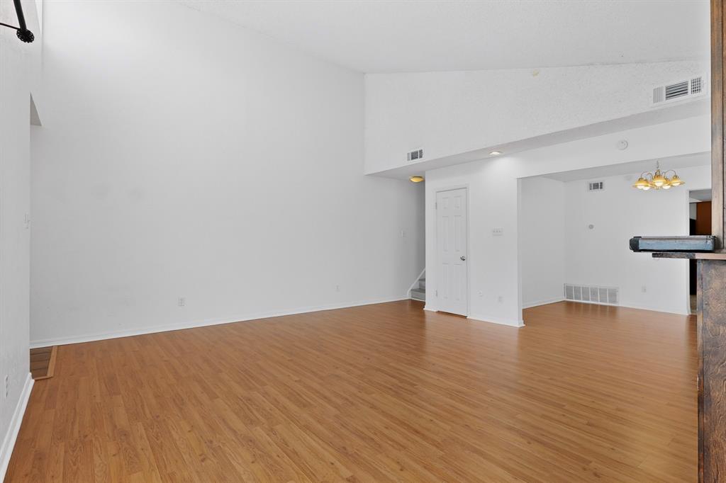 635 Haines Avenue Dallas, TX 75208 - Photo 10 of 36 a view of an empty room with wooden floor