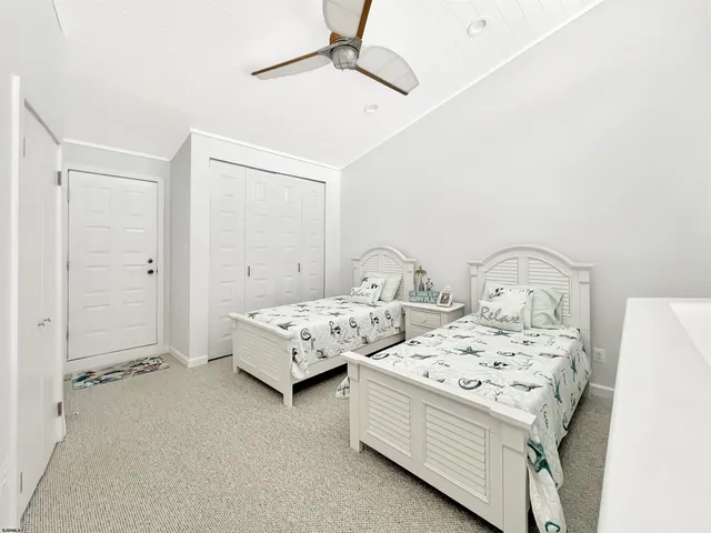 a bedroom with bed and a chandelier