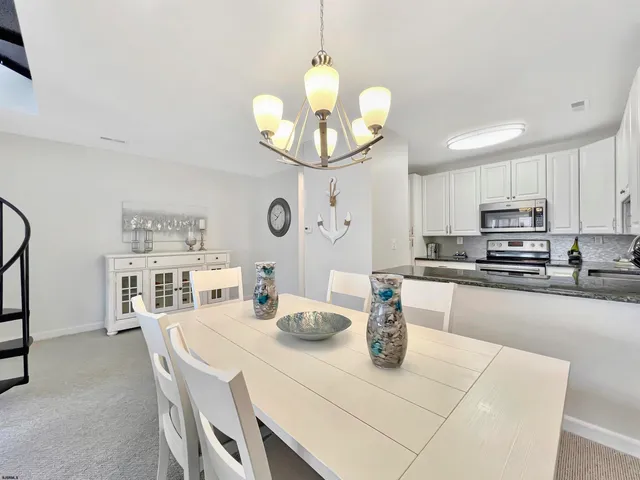 a view of a dining room with furniture and a large window
