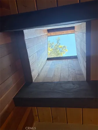 a wooden bench sitting in front of a window