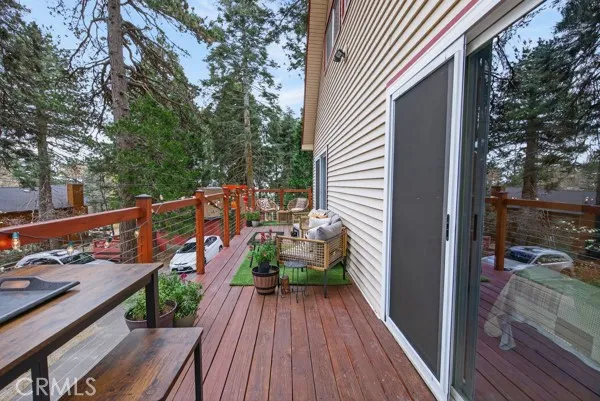 a balcony with wooden floor and potted plants