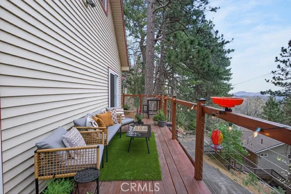 a balcony with wooden floor and outdoor seating
