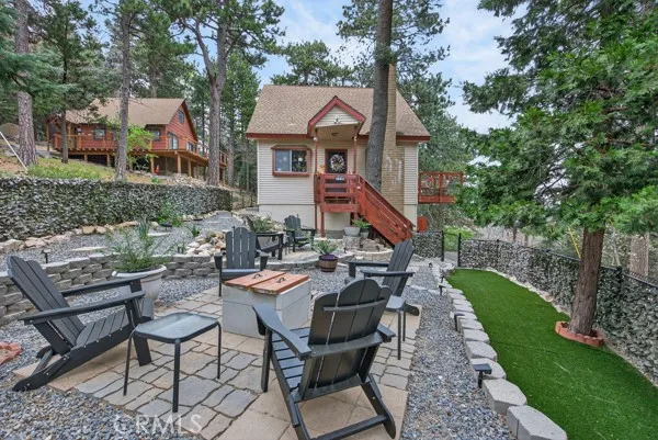 a view of a house with backyard sitting area and garden
