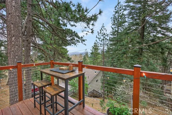 a view of a balcony with wooden floor and outdoor seating