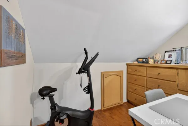 a view of a workspace with furniture and mirror