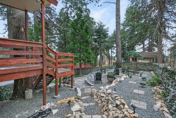 a backyard of a house with barbeque oven and outdoor seating