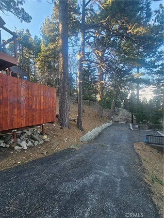 a view of a yard with wooden fence