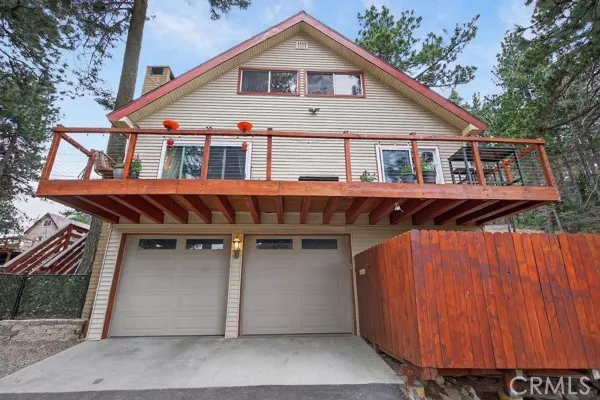 a view of a house with wooden deck