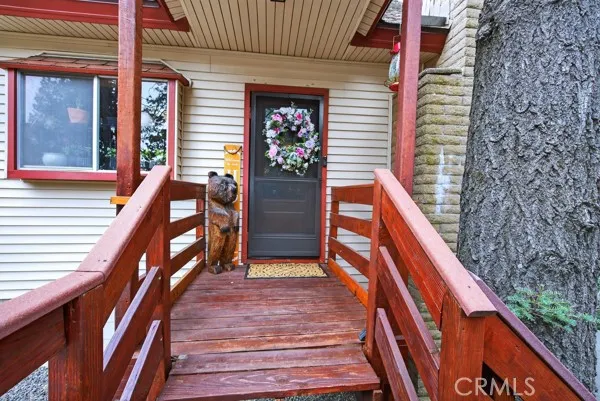 a balcony with wooden floor and stairs