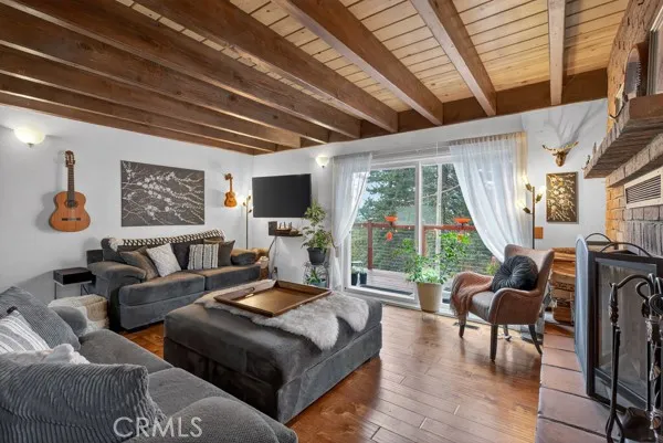 a living room with furniture a flat screen tv and a large window