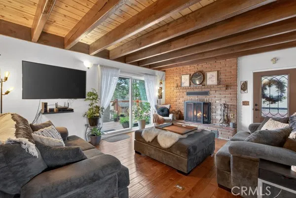 a living room with fireplace furniture and a flat screen tv