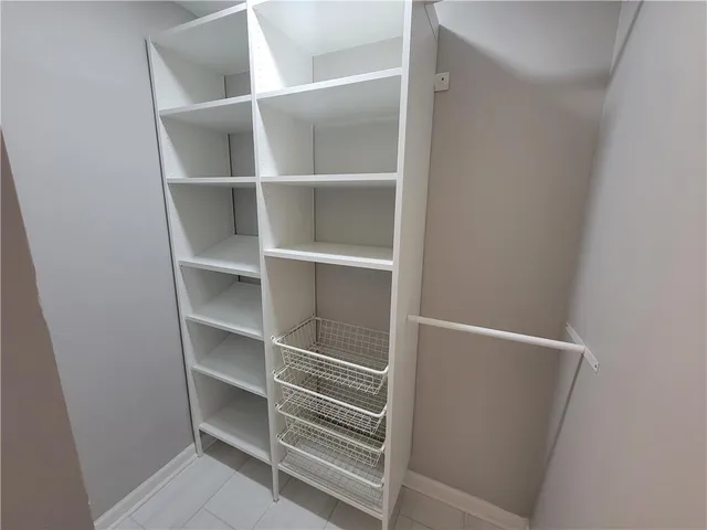 a view of walk in closet with empty racks