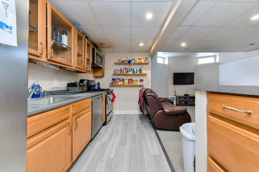 748 East 3rd Street, Unit A Boston, MA 02127 - Photo 2 of 16 a large kitchen with stainless steel appliances granite countertop a lot of counter space a sink and a refrigerator