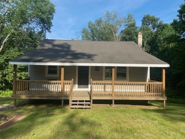 a view of a house with a yard in the background