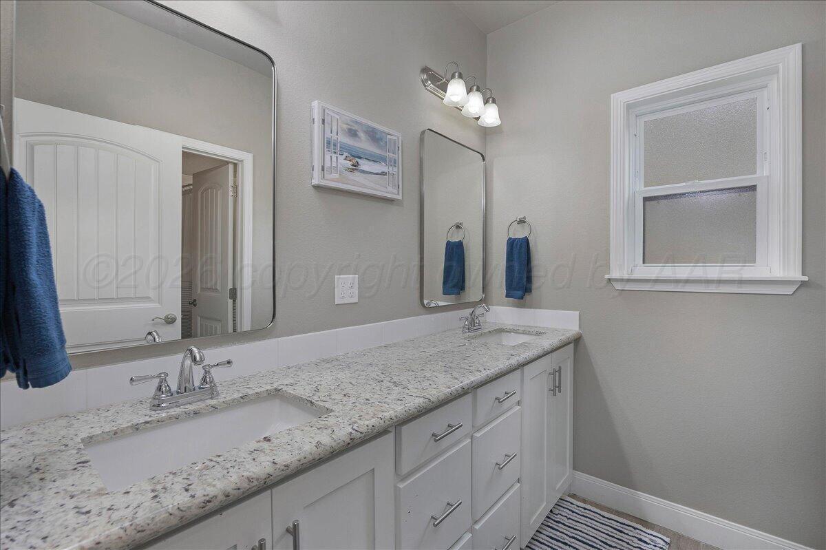 39 Cm Lane Canyon, TX 79015 - Photo 18 of 26 a bathroom with a granite countertop sink and a mirror