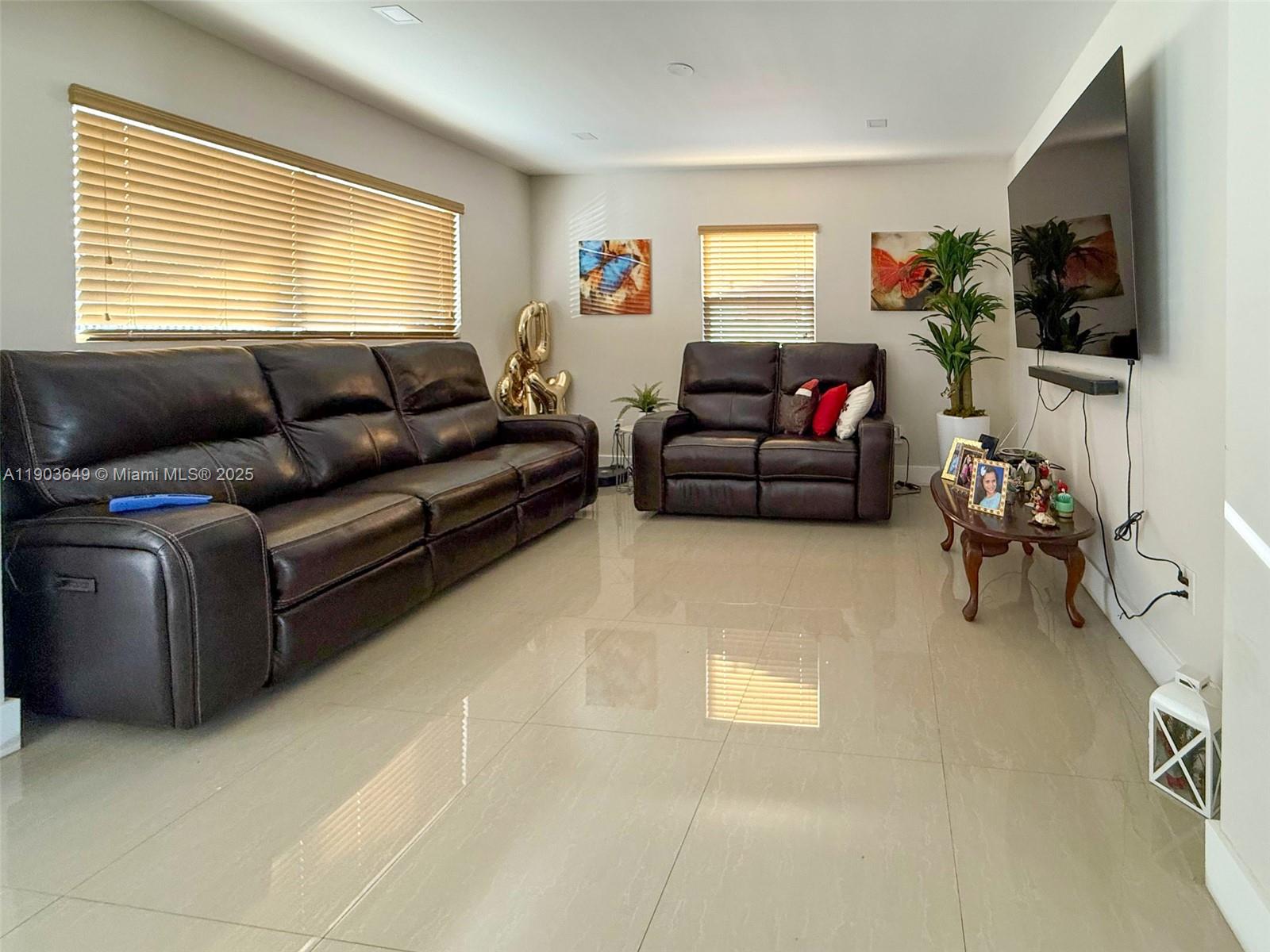 1545 Northwest 85th Street Miami, FL 33147 - Photo 5 of 16 a living room with furniture and a flat screen tv