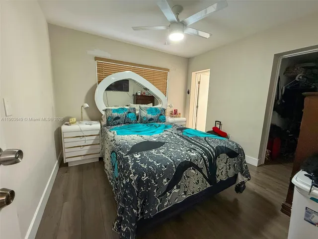 a bedroom with a bed and a mirror