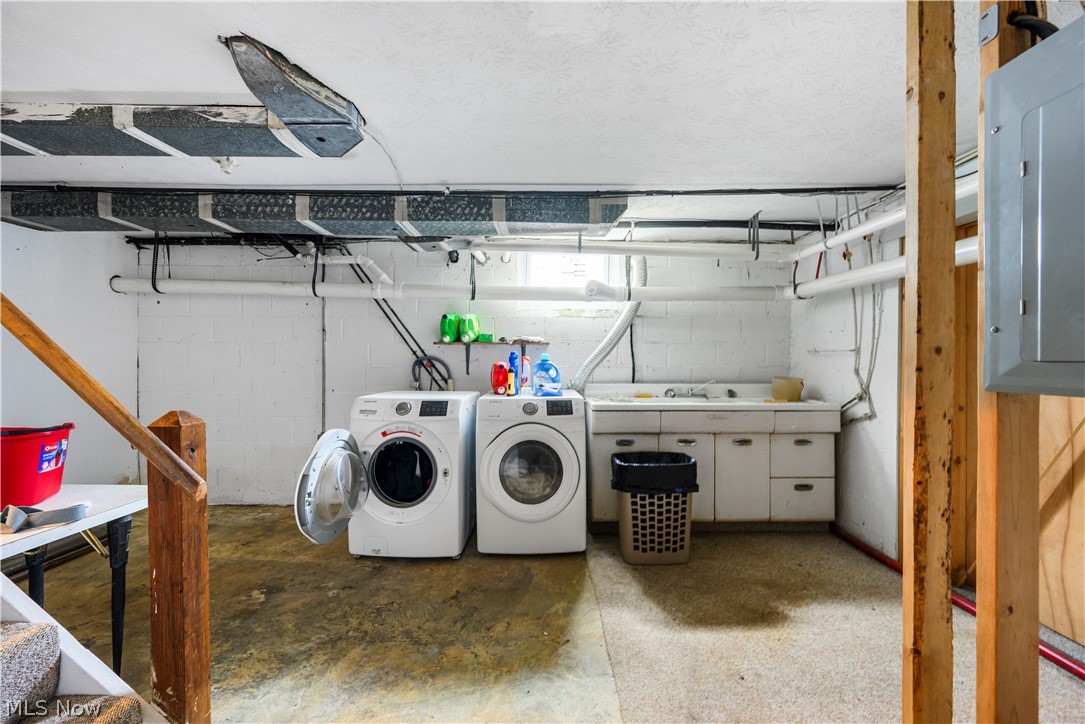4001 South Cleveland Massillon Road Barberton, OH 44203 - Photo 25 of 25 Laundry room featuring electric panel, unfinished concrete flooring, and independent washer and dryer