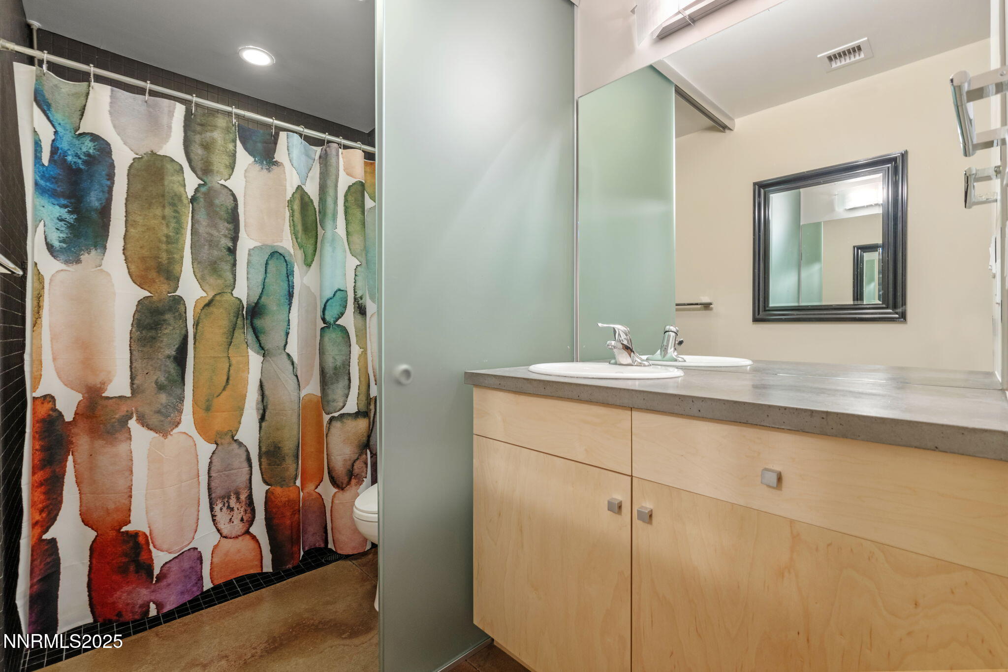 880 South Center Street Reno, NV 89501 - Photo 11 of 54 a bathroom with a double vanity sink and mirror