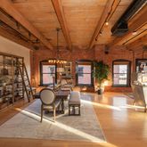 a living room with furniture a chandelier and large windows