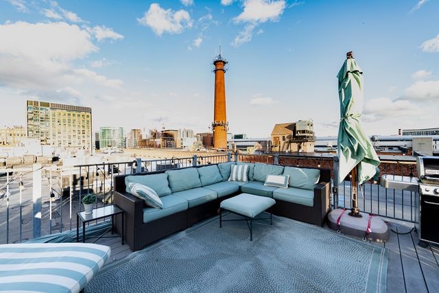 a living room with furniture a rug and a chandelier