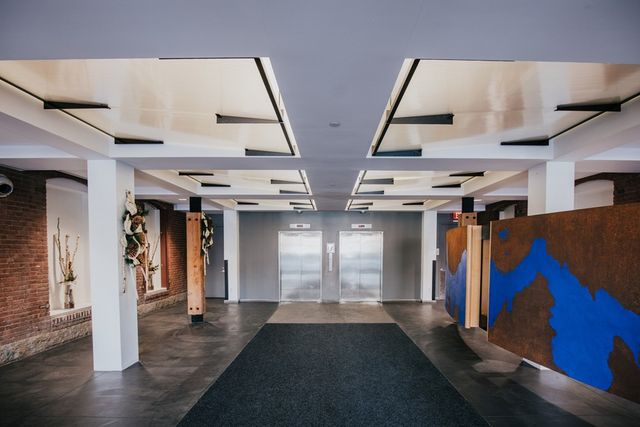 a view of hallway with stairs and wooden floor