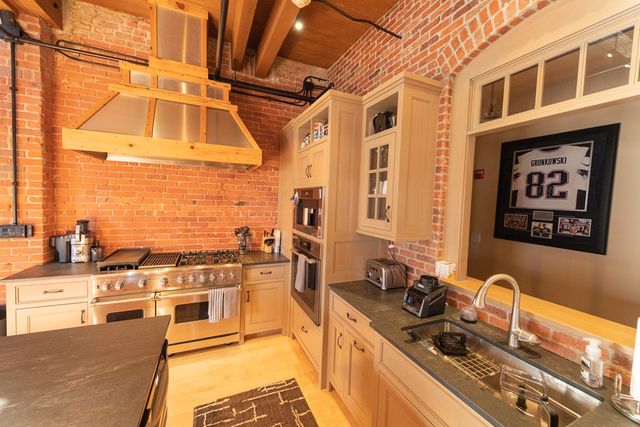 a kitchen with stainless steel appliances granite countertop a stove and a sink