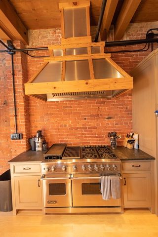 a stove top oven sitting inside of a kitchen