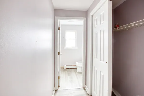 a view of a room with wooden floor and window