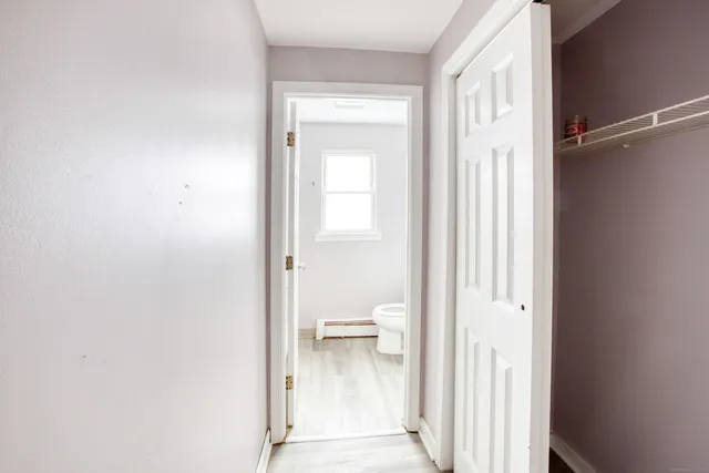 a view of a room with wooden floor and window