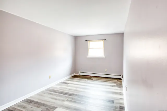 a picture of a bench in front of a wall