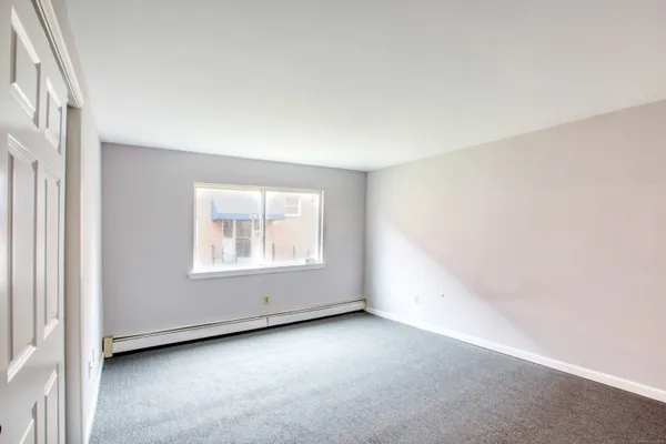 a white toilet sitting next to a window