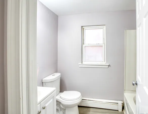 a kitchen with granite countertop cabinets stainless steel appliances a sink and a window
