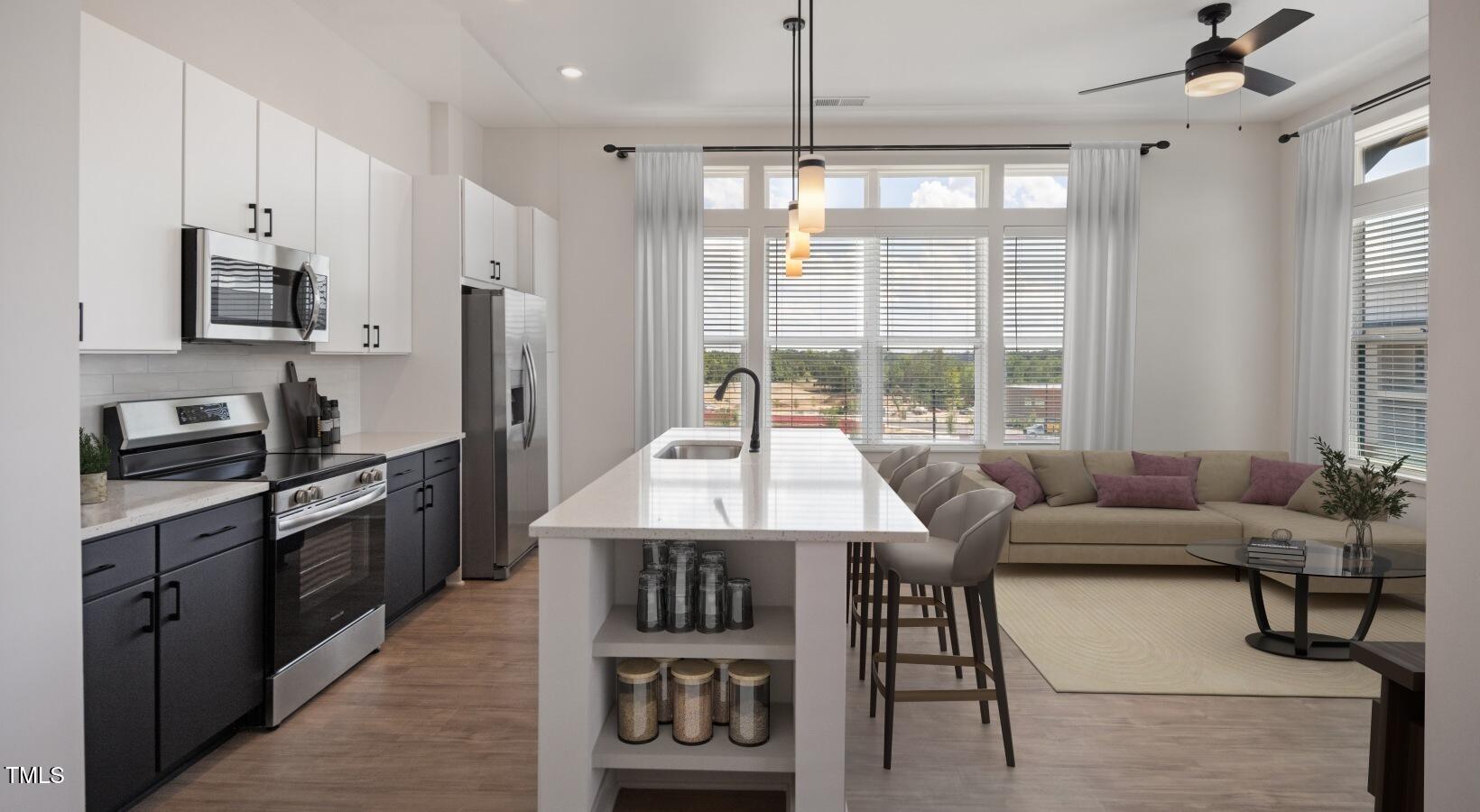 1821 Chatham Flats Drive, Unit A1 Apex, NC 27502 - Photo 6 of 12 a open kitchen with stainless steel appliances granite countertop a stove and a refrigerator