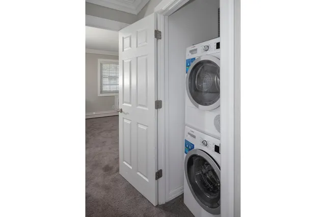 a view of a hallway with washer and dryer