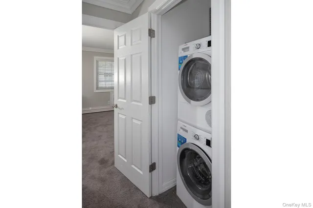 a view of a hallway with washer and dryer