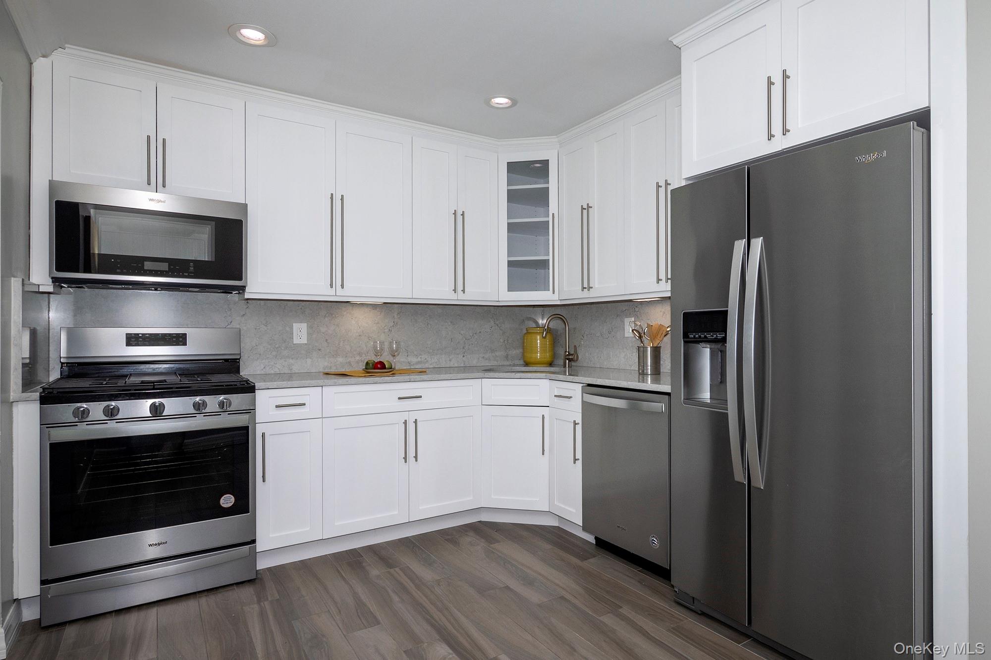 100 Terrace Road, Unit T09340 Bayport, NY 11705 - Photo 5 of 14 a kitchen with stainless steel appliances a refrigerator stove and microwave