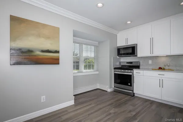 a kitchen with wooden floors and a stove